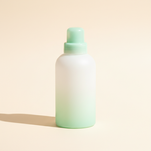 Minimal baby laundry detergent bottle in a warm studio setting