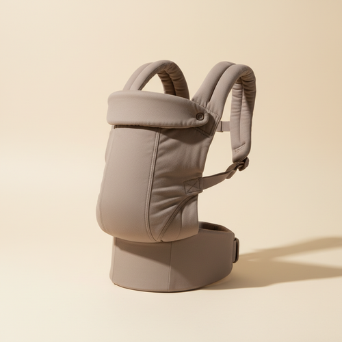 Taupe ergonomic baby carrier in a warm studio setting